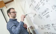 Person writing equations on white board, image, largely for decoration