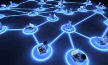 A CGI image of several people sitting at their computers, all interconnected by a web