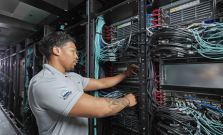 Someone working in the hardware of a supercomputer